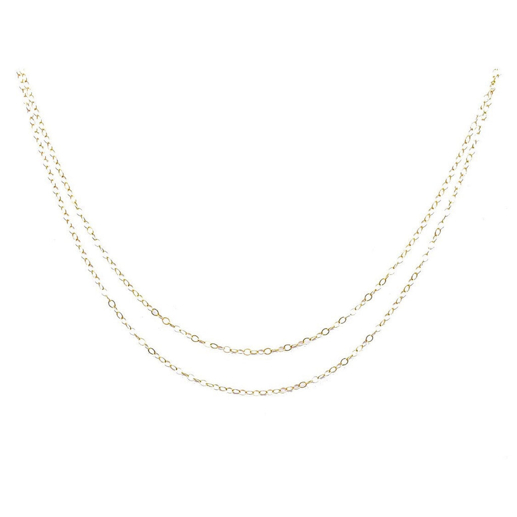 Two delicate gold layered flat cable chains.